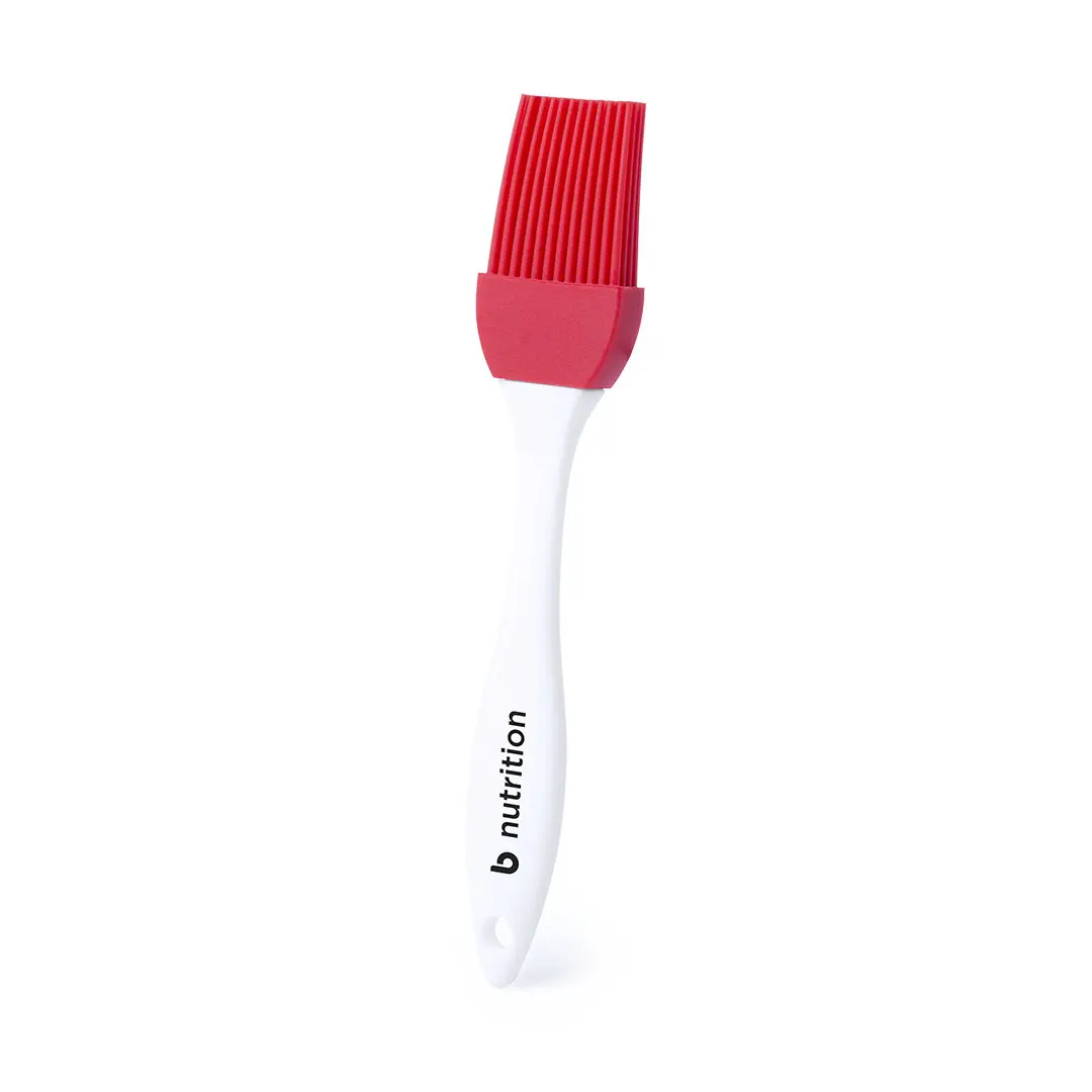 Brocha de silicona con cerdas rojas y mango blanco con el logo b nutrition