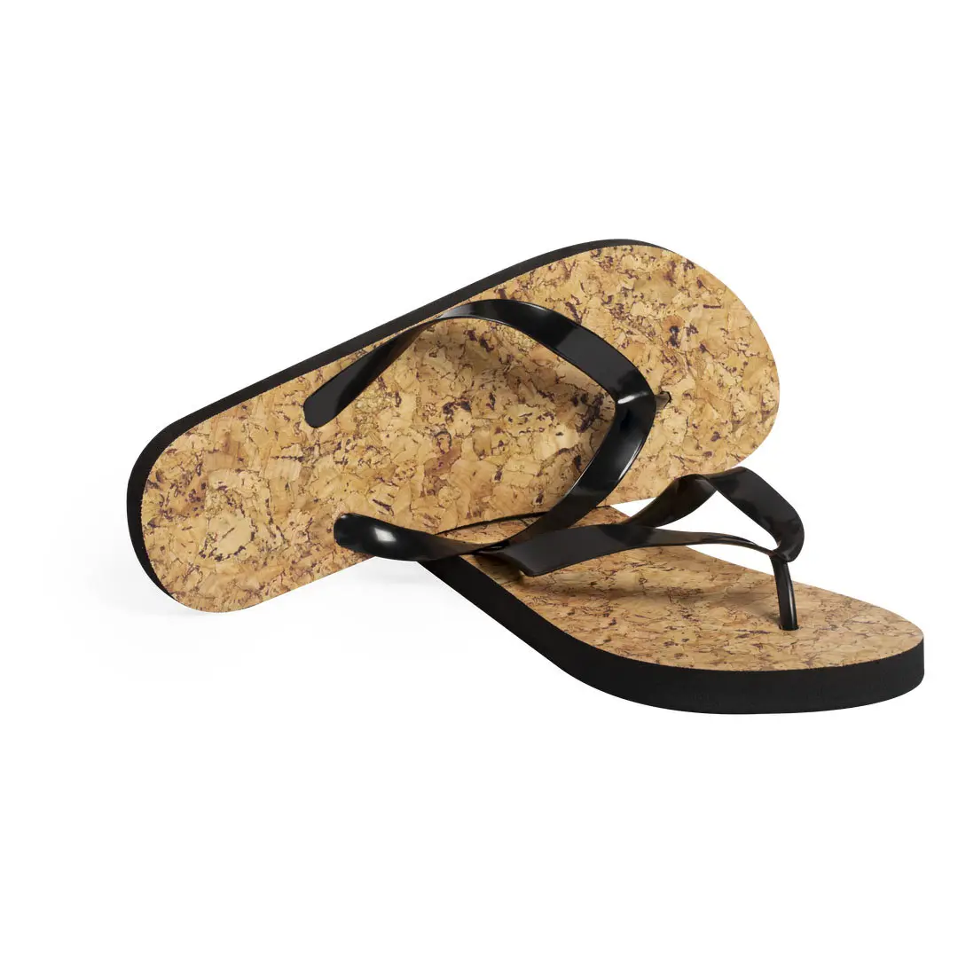 Chanclas con suela de corcho texturizado y tiras negras sobre fondo blanco