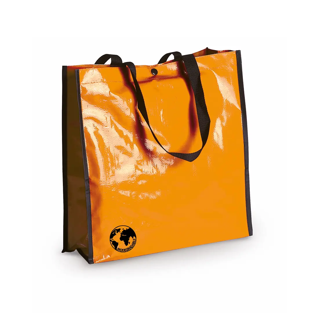 bolsa reutilizable de color naranja con asas negras y logo de biodegradabilidad