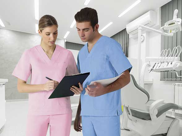 dos profesionales de la salud dental, mujer con uniforme rosa y hombre con uniforme azul, revisan un informe en una clínica dental moderna